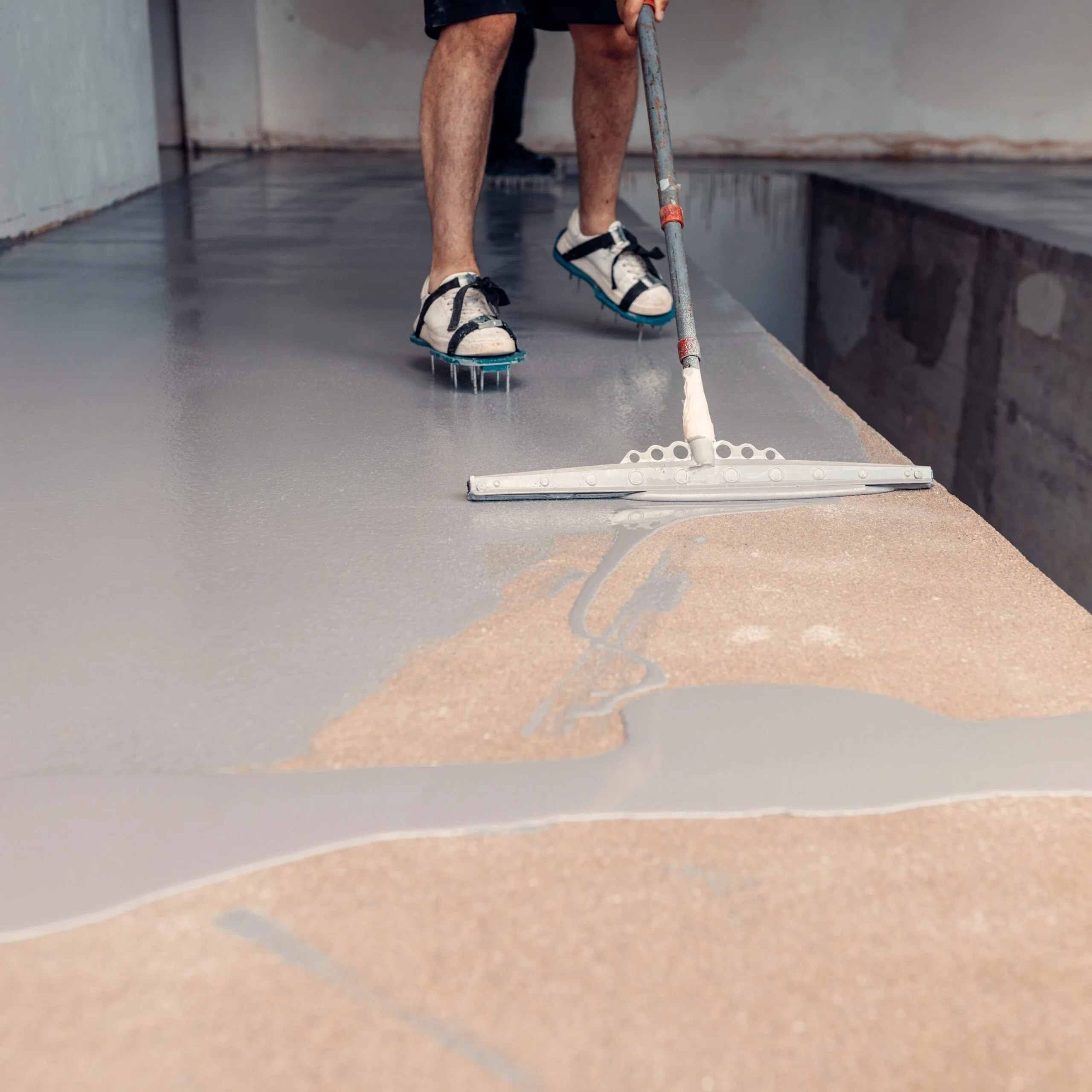 Epoxy floor installation in an Albuquerque auto repair shop by 505 Garage Floors, resisting oil, grease and hot tires.
