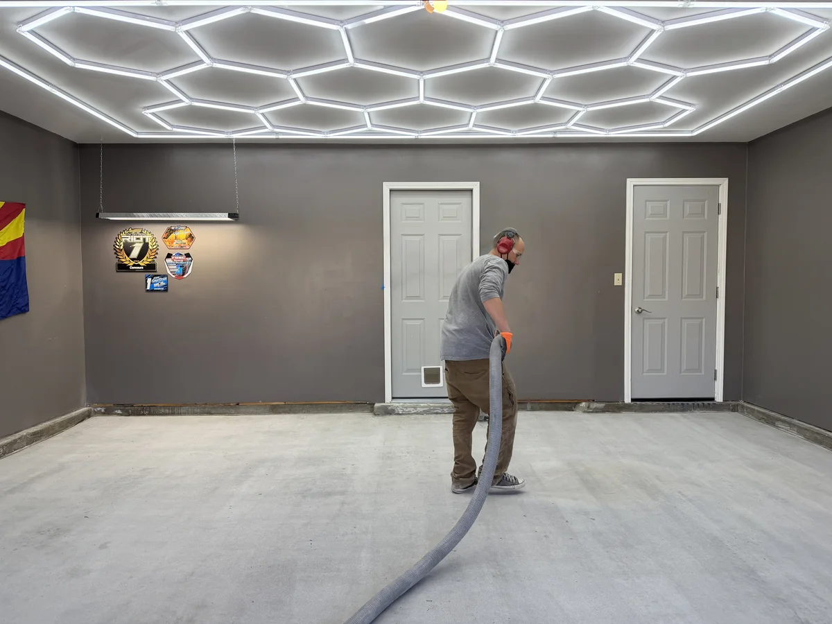 505 Garage Floors technician applying a polyaspartic topcoat to a residential garage floor in Albuquerque, New Mexico