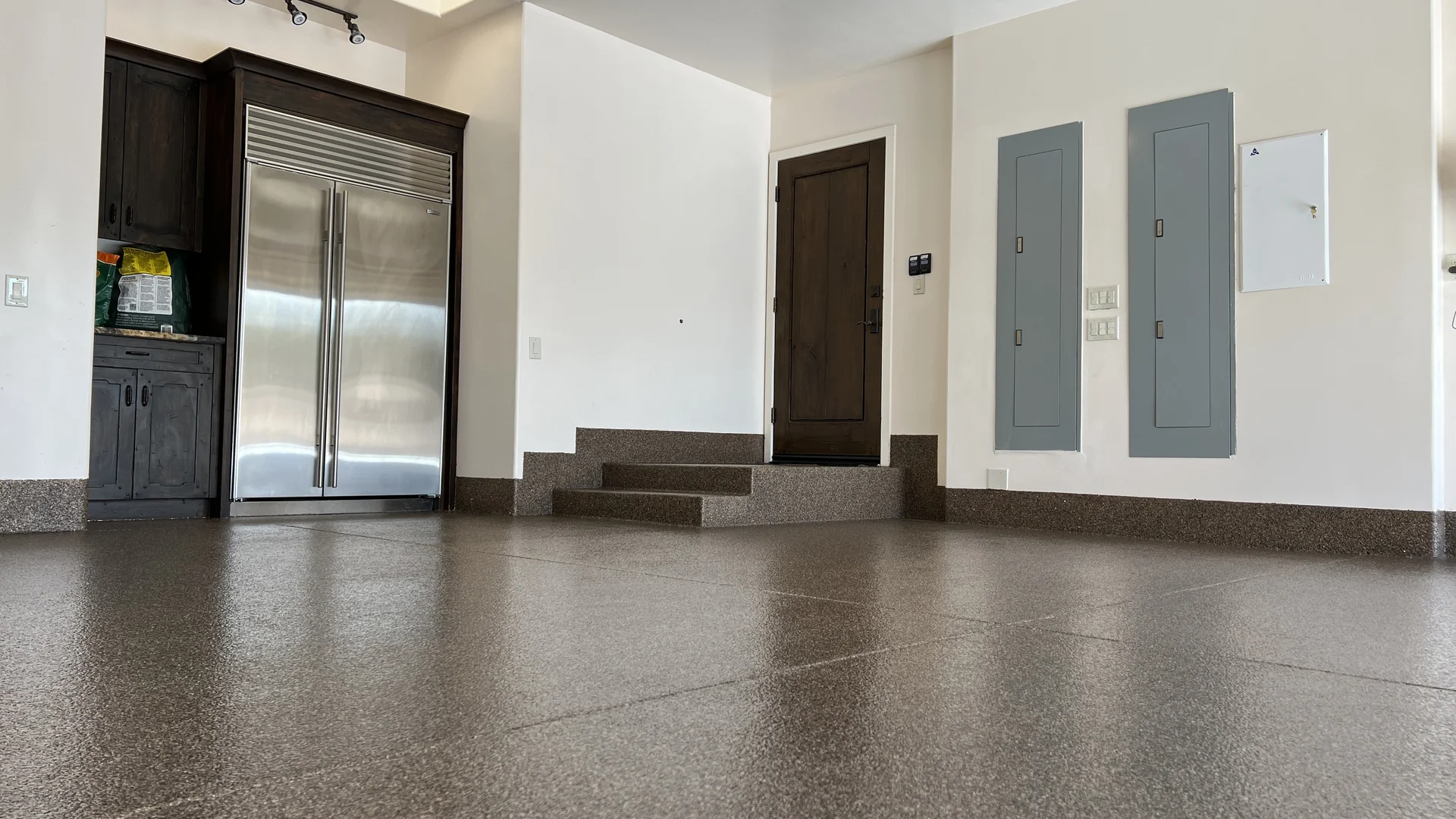 High-gloss epoxy flake garage floor coating in a two-car garage, professionally installed by 505 Garage Floors in Albuquerque, NM