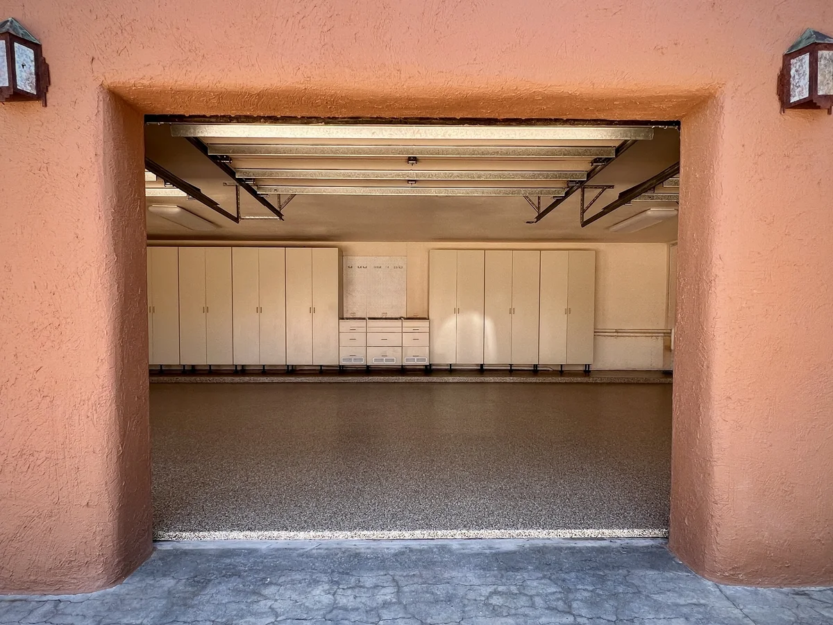 Metallic epoxy garage floor with a seamless polyaspartic topcoat, professionally installed in an Albuquerque, NM residential garage